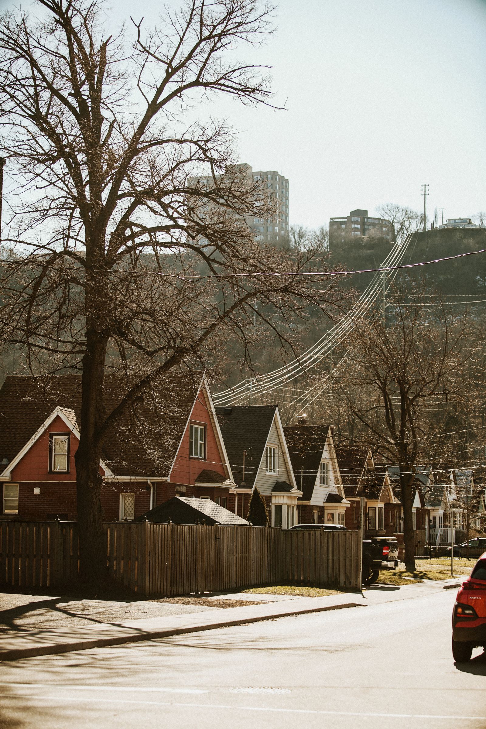 Row of 1990s single-story houses along a quiet residential street