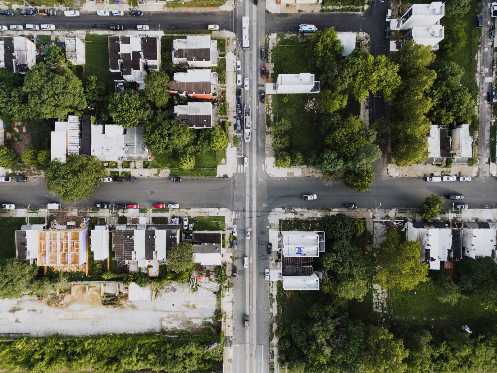 Wide suburban road intersection with turn lanes and traffic signals