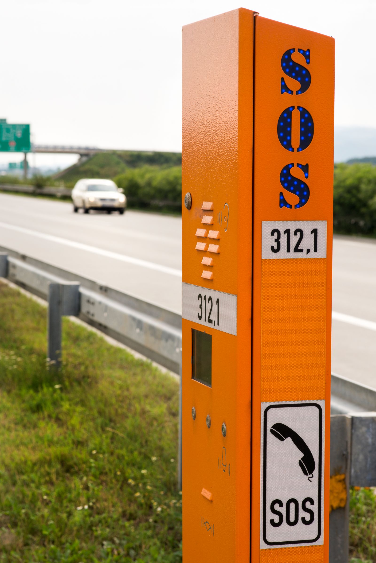 Emergency call box mounted on a post at the side of a highway